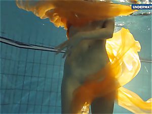 Yellow and red dressed teenage underwater